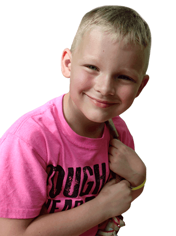 Child in a pink T-shirt smiling and holding a strap over shoulder.